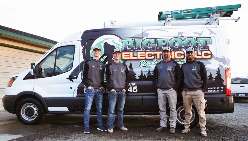 Bigfoot Electric crew standing beside a work van