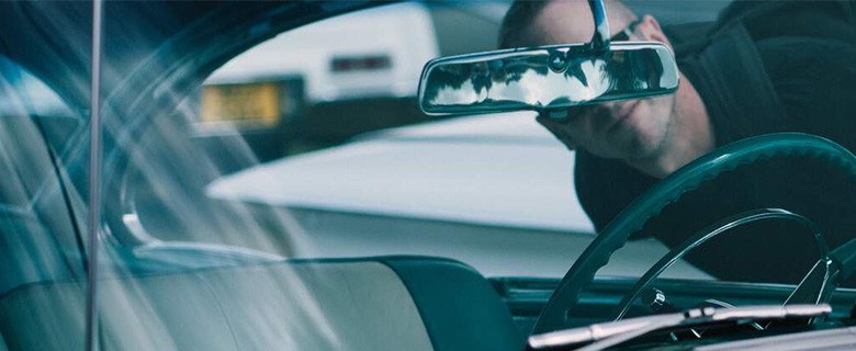 Car windshield and rear-view mirror seen from inside the vehicle